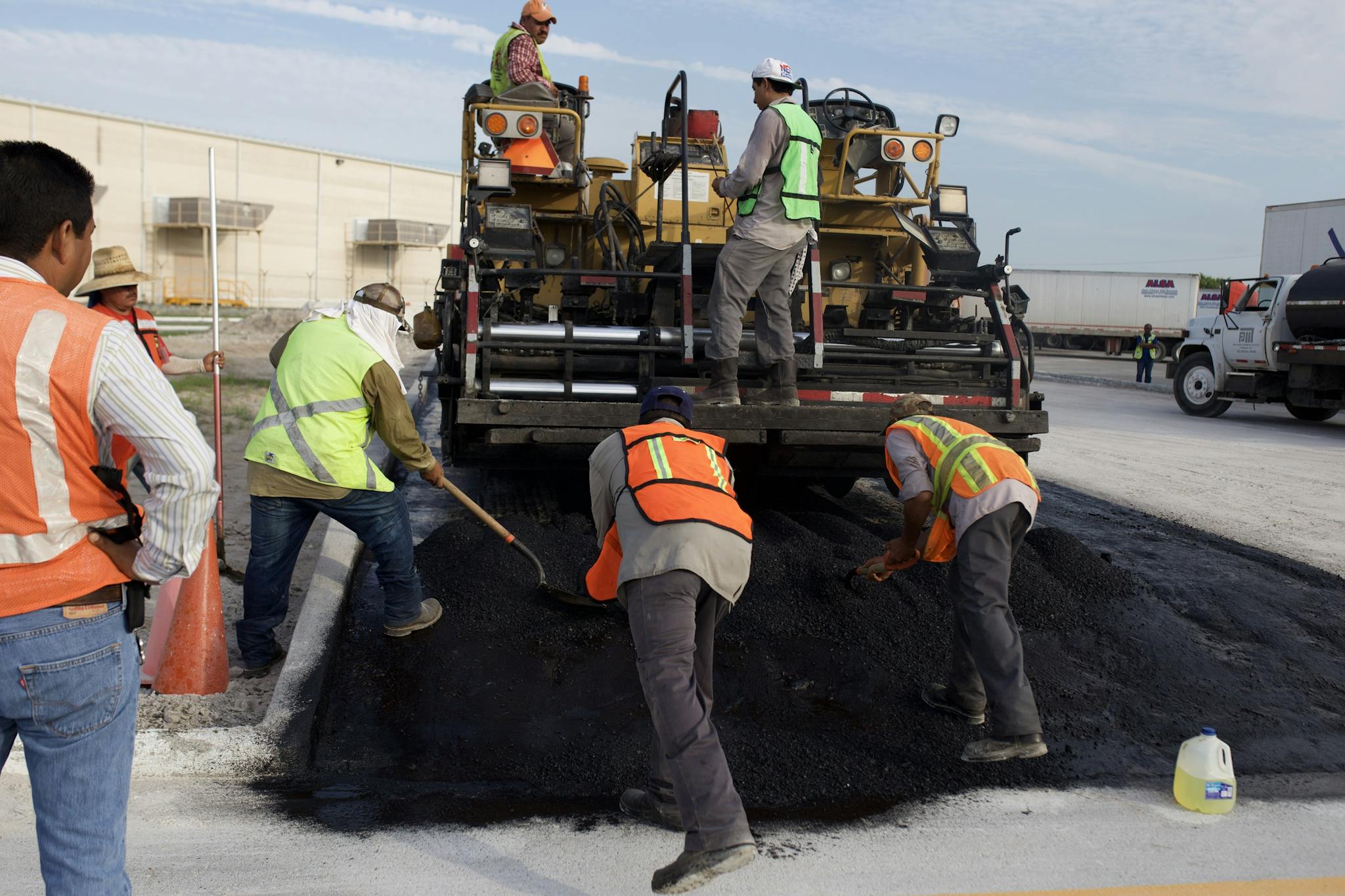 Men Putting Asphalt on the Road